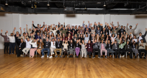 the whole scileads staff in a big group shot with their hands in the air in celebration